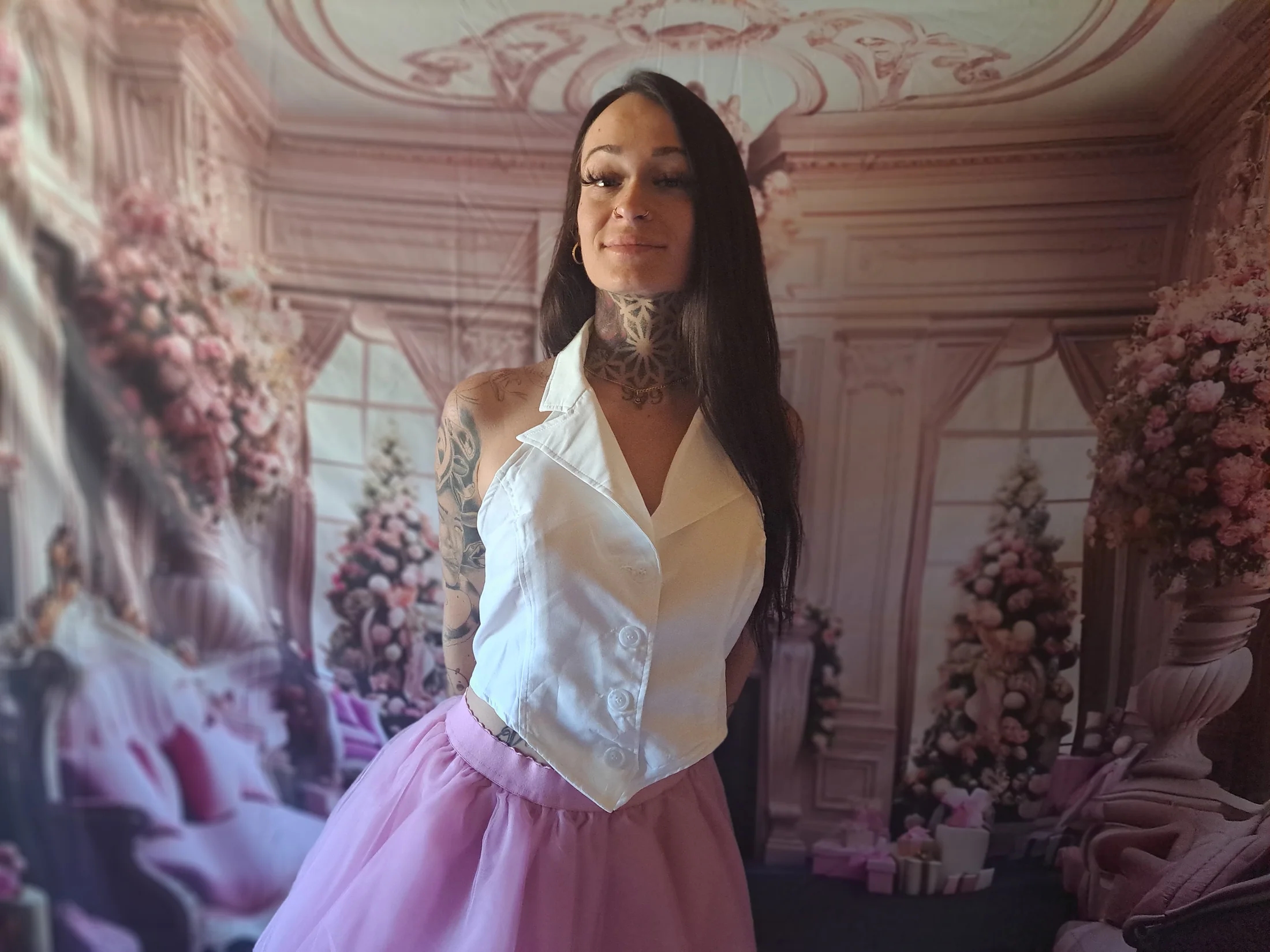 First Place Parties host posed in front of an elegant blush floral backdrop
